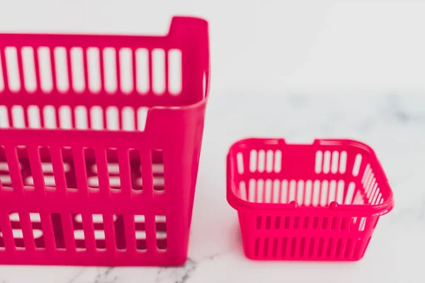 Big vs small budget concept with different size shopping baskets — Stock Photo, Image