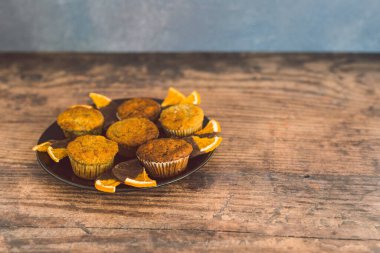 Siyah çikolata kaplı, portakal dilimli vejetaryen muzlu kekler.