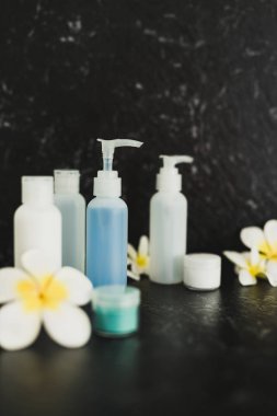 lotions and moisturizer bottles on black marble shot at shallow 