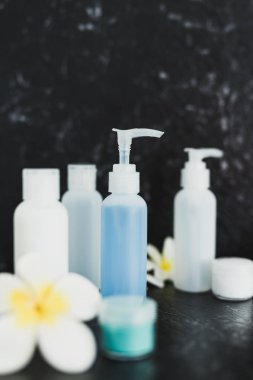 lotions and moisturizer bottles on black marble shot at shallow 