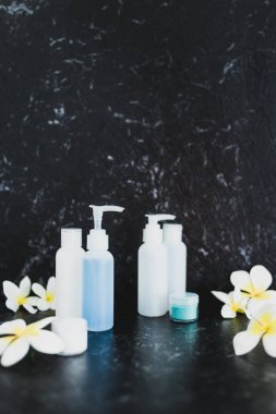 lotions and moisturizer bottles on black marble shot at shallow 