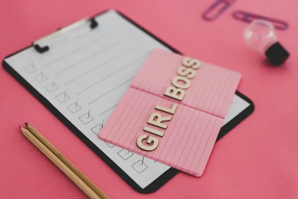 equal opportunity and fairness in society conceptual still-life, Girl Boss text on top of pink notebook on business office desk with to do list and mixed stationery on pink background