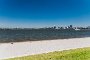 PERTH, WESTERN AUSTRALIA - December 28th, 2019: view of the Swan River and Perth skyline and coastline as seen from a pedestrian and bike track next to the city CBD