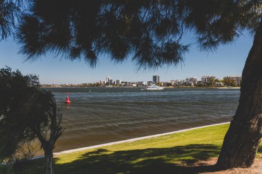 PERTH, WESTERN AUSTRALIA - December 28th, 2019: view of the Swan River and Perth skyline and coastline as seen from a pedestrian and bike track next to the city CBD