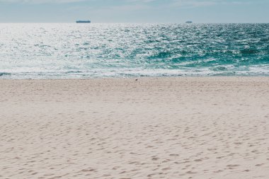 PERTH, WESTERN AUSTRALIA - January 4th, 2020: view of Scarbourough beach with container ships in the distance, the locatin is one of Perth's most popular beaches
