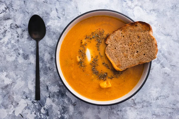 healthy plant-based food recipes concept, homemade vegan carrot and cauliflower soup with sourdough bread