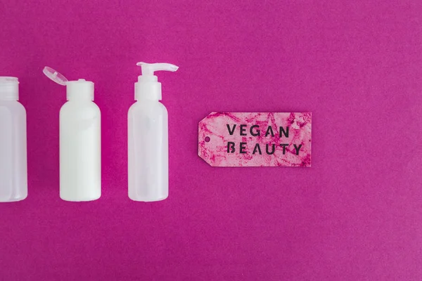 cruelty-free beauty products with no animal testing concept, group of moisturizers and toner lotions with Vegan Beauty message on label next to them