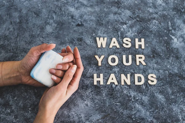 keep clean to fight bacteria and viruses, hand holding soap next to Wash your Hands text