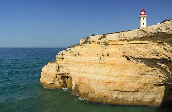 Lighthouse on the big yellow rock — Stock Photo, Image