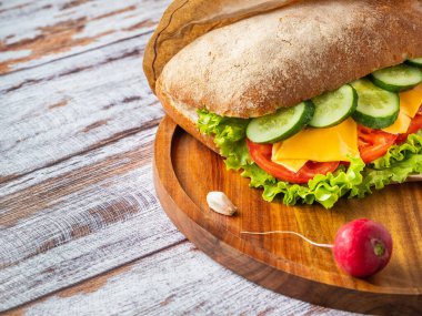 Ahşap tabakta vejetaryen ciabatta ve arka planda fotokopi alanı olan kırmızı turpu yakından izle.