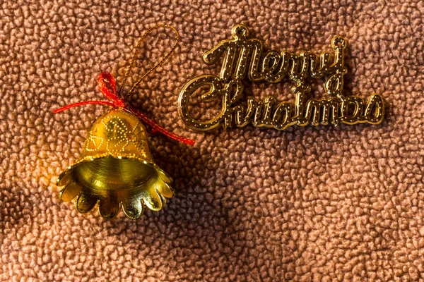 Bell with Merry christmas word on fabric, still life — Stock Photo, Image