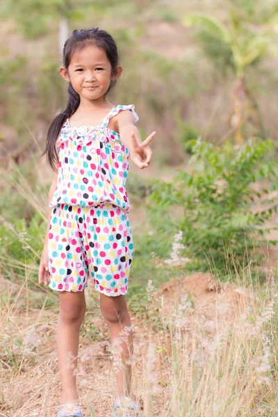 Thai girl in Grass flower field — Stock Photo, Image