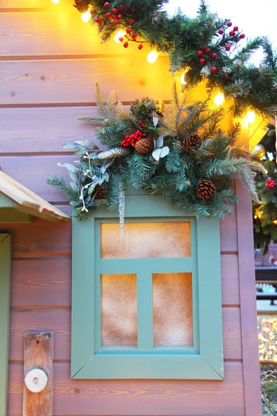 Christmas facade street window decoration with fir branches, pine cones and berries