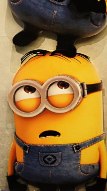 OSAKA, JAPAN - Nov 13, 2019 : Close up HAPPY MINION statue in Universal Studios Japan. Minions are famous character from Despicable Me animation. clipart