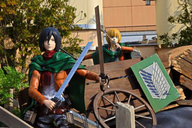 Osaka, Japan - Jan 20, 2020: Clone-oid statue of Mikasa Ackerman and Armin Arlelt from Attack on Titan ( Shingeki no Kyojin ) /Race for Survival XR Ride at Universal Studios japan. clipart