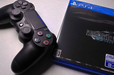 Osaka,Japan - Apr 10,2020 : View of Final Fantasy 7 Remake Game software packages with PS4 Joystick.Remade for the first time in 26 years and released worldwide at the same time. clipart
