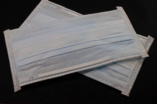 Surgical protective mask. Medical respiratory bandage face Shortage of masks on a white color background. prevention of the spread of virus and pandemic COVID-19.Mask export regulations.