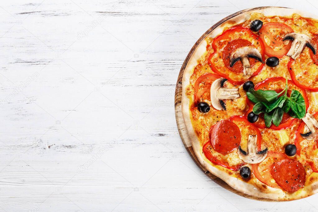 Top view of Italian rustic PIZZA with mushrooms, basil, tomato, olives and cheese and bacon. WITHOUT one piece.  white wooden table background. Look as Prosciutto, Capricciosa, Funghi, Cotto PIZZA. Ideal for commercial