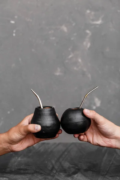 A man sharing Yerba Mate tea in gourd with sipped metal straw.  Famous hot drink in South America. Best for commercial