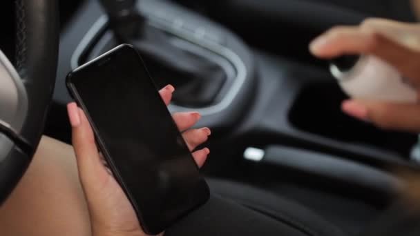 Lady pulvérisation désinfectant sur le téléphone intelligent pour éviter la propagation du virus de la couronne. Un assainissement régulier assure la sécurité contre le virus .