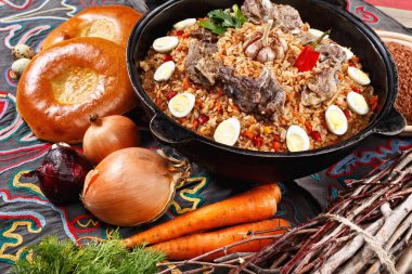 Flat lay of Uzbek PILAF. Traditional Uzbek setup with plov dish in centre decorated with bread, vegetables. Middle asian concept clipart