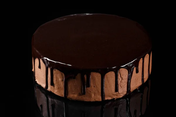 Delicious chocolate mousse cake coated with shiny chocolate glaze. Lava cake. Confectionery photography concept.