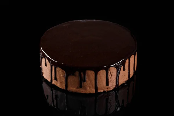 Delicious chocolate mousse cake coated with shiny chocolate glaze. Lava cake. Confectionery photography concept.