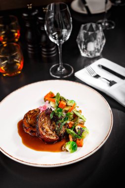 Sağlıklı ana yemek fro vejetaryen. Soslu patlıcan ve yanında da lezzetli sebzeler. Yemek fotoğrafçılığı yemek kitabı ya da dergi için masa arkası konsepti..