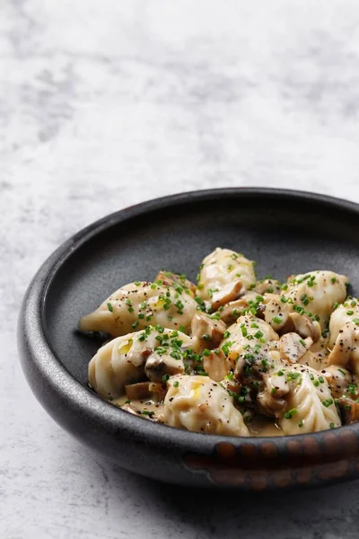 Dumplings with rabbit meat. Rabbit pelmeni with truffle oil. Hiqh quality photo. Best for promotion. Marble table.  Close-up and top view. Flat lay