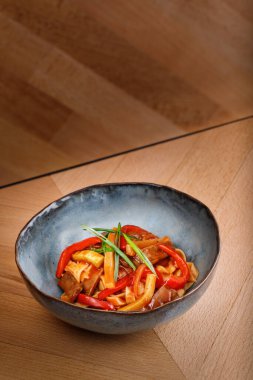 Beyaz soslu, ince dilimlenmiş domuz pastırmalı lezzetli makarna. Üzerinde mavi kâse ve ahşap masa arkasında nane yaprakları var. Fotoğraf en iyi ticari dergi veya restoran kitap menüsü için kullanılır.