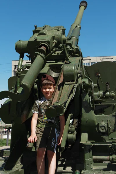 Çocuk ayakta duran bir tanka tırmandı.