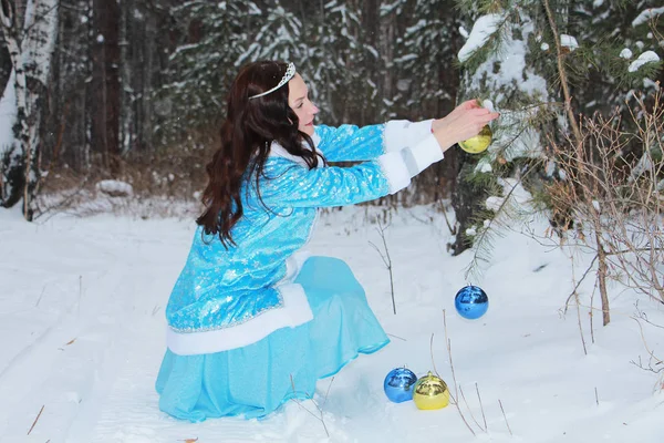 Snow maiden girl walking in the woods