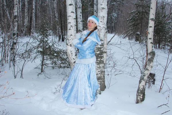 Snow maiden girl walking in the woods