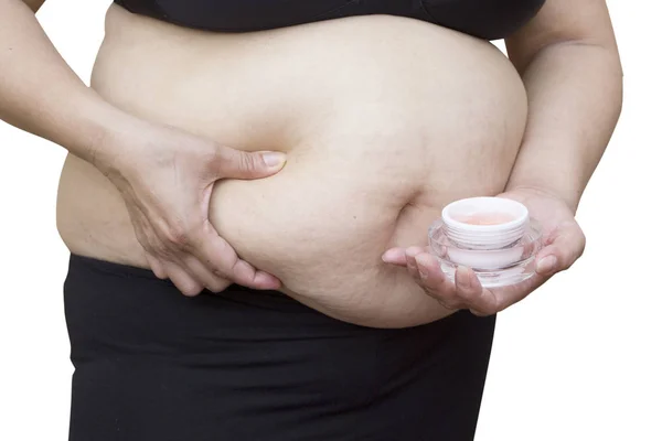 Femme enceinte appliquant de la crème sur son ventre, isolé contre whi — Photo