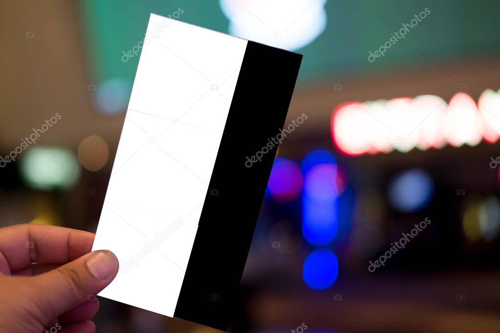 Hand holding three cinema tickets