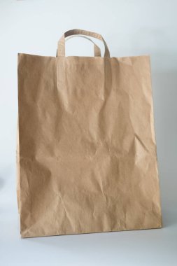 beyaz zemin üzerinde kahverengi kağıt torba