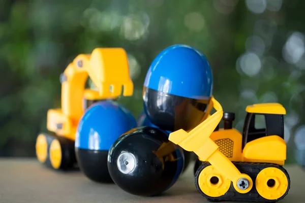 Toy bulldozer carry egg toys open inside mini toy to surprise.