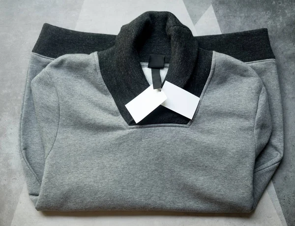 Теплый серый свитер на сером фоне. Теплый свитер — стоковое фото