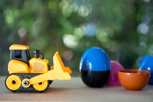 Toy bulldozer carry egg toys open inside mini toy to surprise.