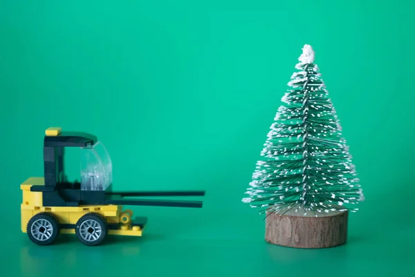 Excavadora modelo de juguete mover árbol de Navidad fin de temporada — Foto de Stock