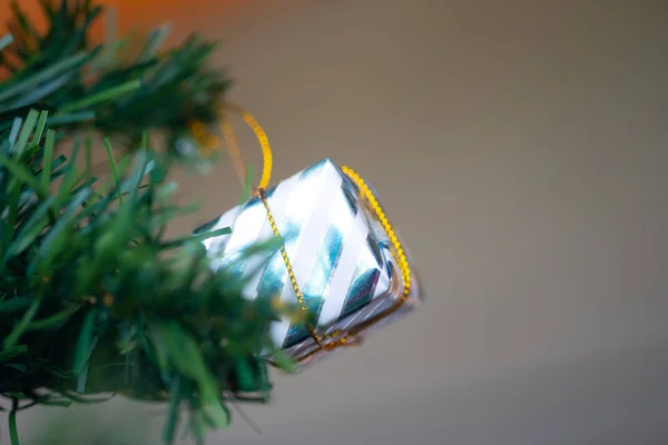Box hanging on the branches of an artificial Christmas tree — Stock Photo, Image