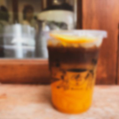 Blur background espresso shot mixed with orange juice