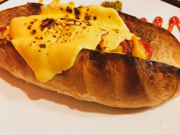 Baked bread sausage with cheese — 스톡 사진