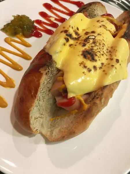 Baked bread sausage with cheese — 스톡 사진