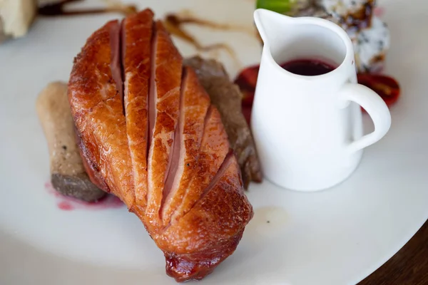 Smoked duck meat served with sauce