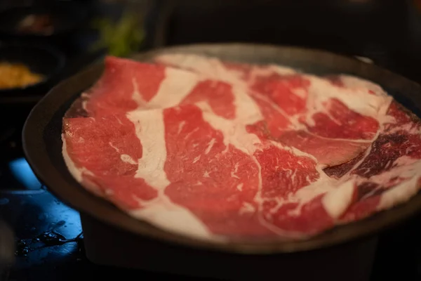 Thin sliced beef on black dish — Stock Photo, Image