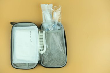 Ustura, tarak, diş fırçası ve havluyla küçük çanta çantalarını gezdir.