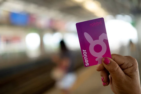 Bangkok, Thailand - 13 februari 2020: Gammal kvinna innehav av senior Bts kort biljett på Bts sky tågstation. Glad turist äldre kvinnor över 60 år — Stockfoto