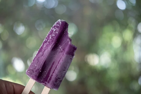 Bite of grape flavored popsicle