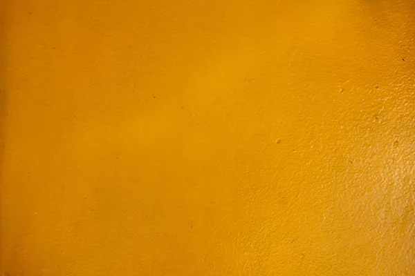 Die gelbe Textur der Betonwand und des Hintergrunds. — Stockfoto
